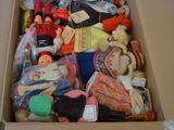 a cardboard box filled with assorted toys on the floor