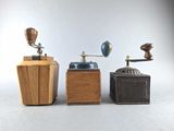 three different types of coffee grinders on a table