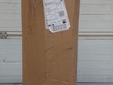 a cardboard box sitting on the ground in front of a garage door