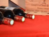 several bottles of wine are lined up on a red table