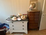 a dresser with hats on top of it in a room