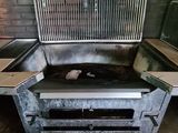 a stove that is sitting in the middle of a room