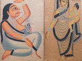 two paintings of a man and a woman hanging on a wall