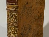 an old book sitting on top of a white table