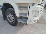 a white truck that is parked on the side of the road