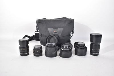 a lot of cameras and a bag on the table