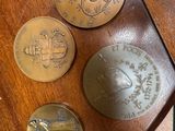 three coins sitting on top of a wooden table next to each other