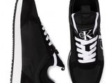 a pair of black and white sneakers on a white background