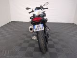 a motorcycle that is parked in a room with a checkered floor