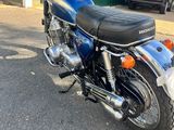 a blue motorcycle parked in front of a building