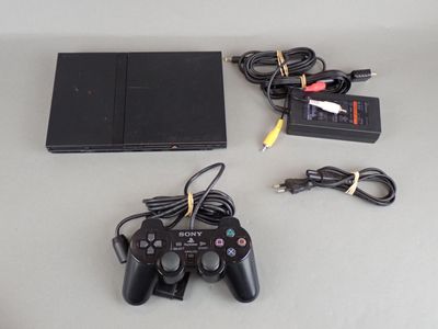 a video game console and a game controller on a table
