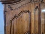 an image of a wooden armoire in a room