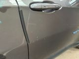 a close up of a car door handle with a sticker on it