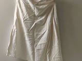 a white shirt hanging on a hanger on a wall