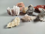 many different kinds of crystals on a white surface