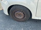 a white car that has a flat tire on it