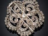 a close up of a broochle on a black surface
