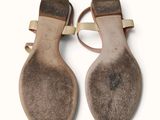pair of brown sandals on a white surface with a white background
