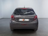 the back of a silver car in a white room with a black floor