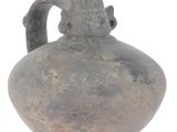 an old vase with a man holding a child on it