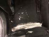 a dirty seat in the back of a car