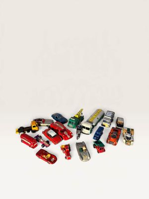 a lot of toy cars that are on a white surface