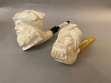 two figurines of a man with a pipe and a pipe holder