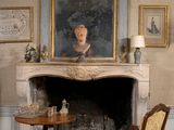 a painting on the wall above a fireplace in a room