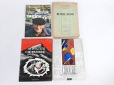 three books on a white table with a picture of a man in a hat and a woman in a hat