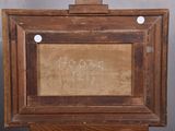 an old wooden easel with a painting on top of it on a table