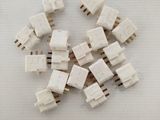 a pile of white electrical connectors on a white surface