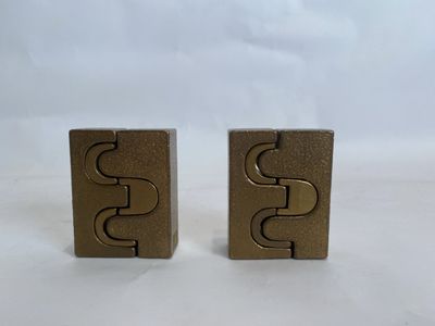 pair of brass plated bookends with the letter s on each side