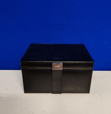 an empty black box sitting on top of a white table