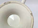 a close up of a cup on a white surface