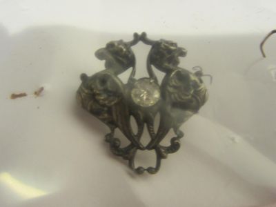 a small metal object that is sitting on a white plate