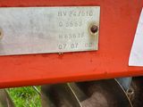 an image of a close up of a tractor with a plow behind it