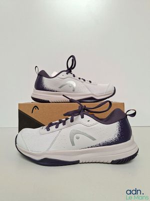 a pair of tennis shoes in a box on a table