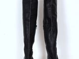 pair of women ' s black leather knee high boots on a white pedestal