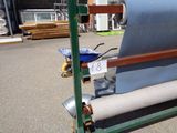 an image of a roll of fabric on a cart