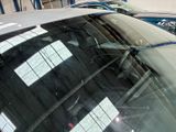 many cars parked in a garage with a lot of windows