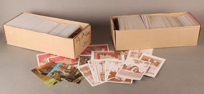 two boxes of cards sitting on top of a table next to each other