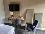 a desk with a mirror and a chair in a room