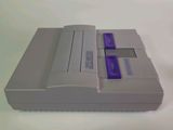 a nintendo wii game controller sitting on top of a white table