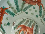 a bowl with fish and plants in it on a table