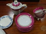 many plates and cups and a teapot on the table