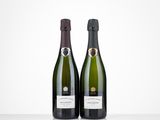 two bottles of champagne sitting on top of a table