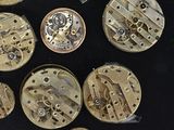 many different types of watches on a black surface