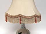 a lamp that is sitting on a table with a lamp shade on it