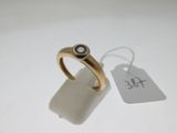 an image of a gold ring with a black diamond on it