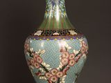 a vase that is sitting on a table with a black background